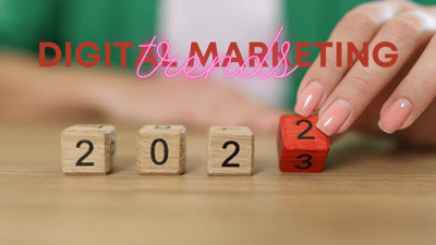 feminine hand turning a block from 2022 to 2023 digital marketing trends