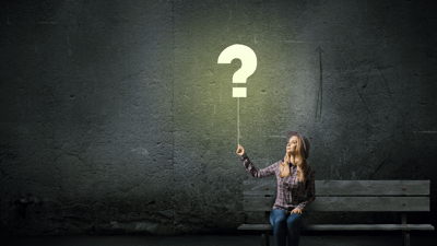 woman sitting on bench with greenish background, turning on question mark shaped light bulb