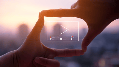 fingers in a picture frame with video play box 