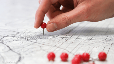 red pins added to black and white map by hand