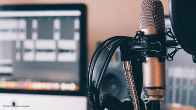 microphone and headphones with computer screen in background