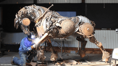 artist John Lopez welding scrap metal to create a horse