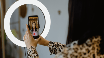 circle light around cell phone for video of woman wearing leopard print shirt