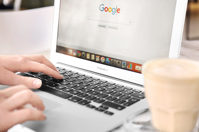 Person typing on a laptop computer.