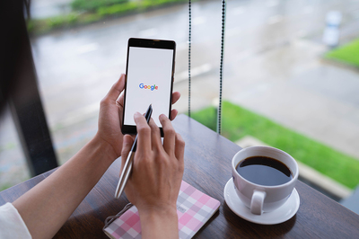 Mobile phone with the Google homepage displayed.