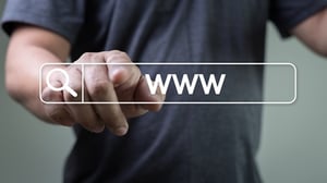 Man pointing to a graphic of a search bar.