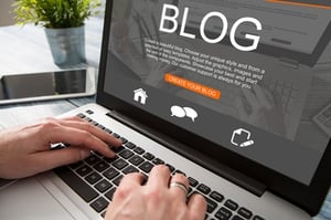 Person creating a blog post on a laptop.