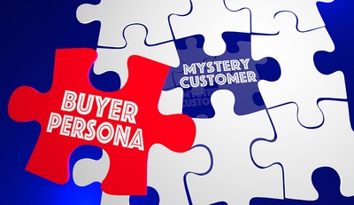 White puzzle pieces with the words mystery customer and buyer persona written on two of them.