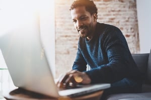 Man working at a laptop computer.