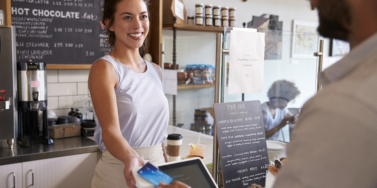 Customer making a purchase at a coffee shop.