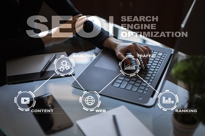 SEO icons over a person working on a laptop.