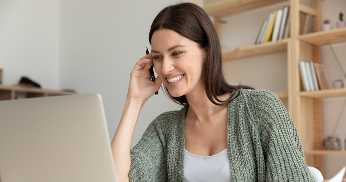 Smiling woman sitting at her desk.