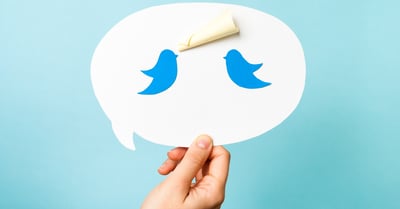Two twitter bird logos in a speech bubble