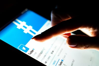 Mobile phone with the twitter app displayed.