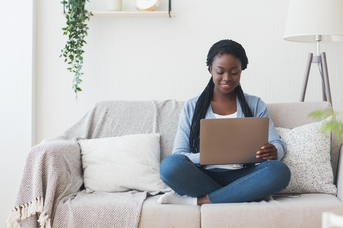 Woman sitting on the couch with a laptop